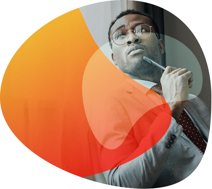 Professional businessman thinking while holding a pen, symbolizing innovation and strategic planning